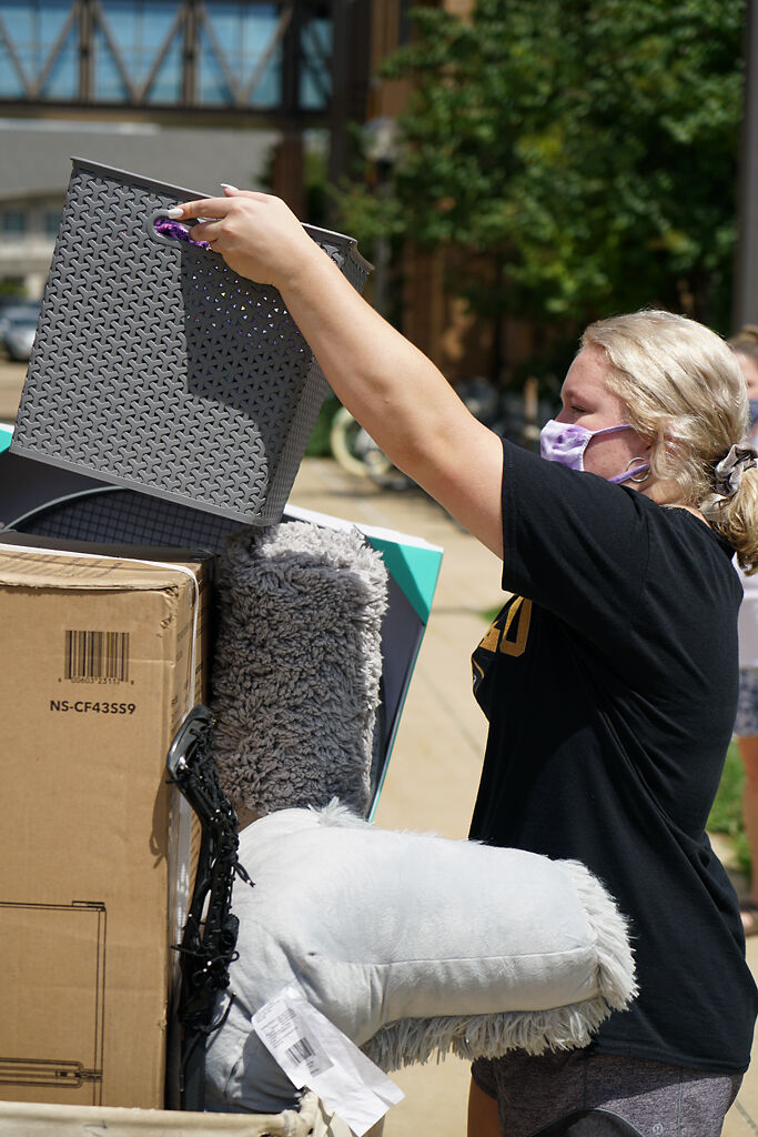 Maddie Gamertsfelder pulls a basket from a stack of boxes Wednesday